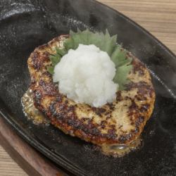 Japanese style meatballs grilled on an iron plate