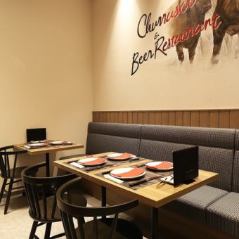 A spacious space that doesn't feel cramped. A table seating for four, perfect for a quick drink after work.