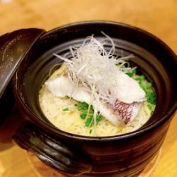 Earthen pot with sea bream soup