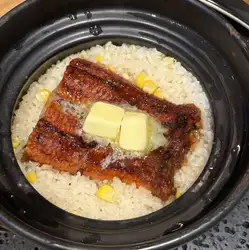 Eel and corn rice cooked in a clay pot with butter and soy sauce.
