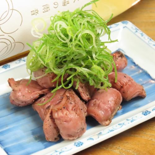 Charcoal grilled gizzards covered in green onions