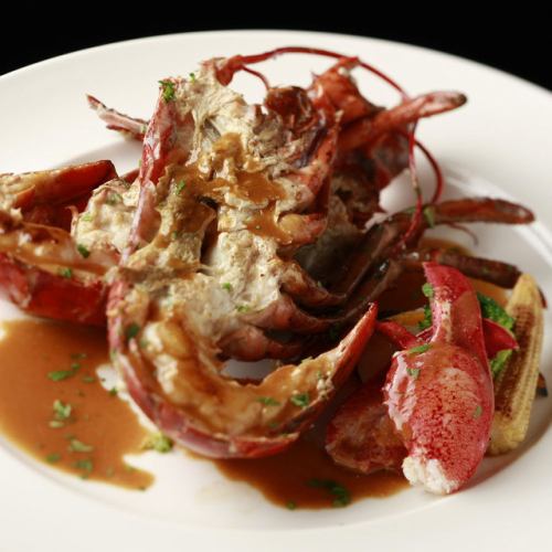 Live lobster poele with colorful vegetables 1 cognac-flavored Americaine sauce