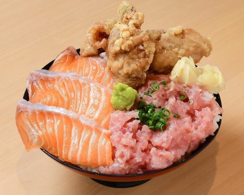Salmon, negitoro (minced tuna with green onions), and fried chicken rice bowl