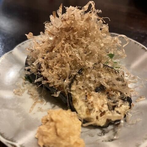 Charcoal eggplant.Chicken stock and bonito flakes