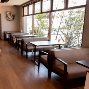 This cafe has a warm atmosphere, created by the wood and plants incorporated into its interior design.
