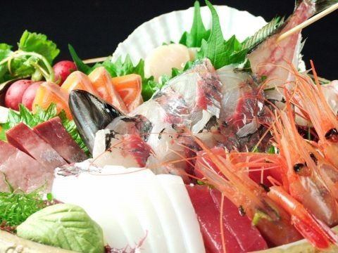 Fresh sashimi including shrimp, yellowtail, shellfish, salmon, raw octopus, red sea bream, and more!
