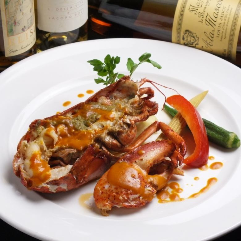 Pan-fried live lobster with colorful charcoal-grilled vegetables and a cognac-flavored American sauce