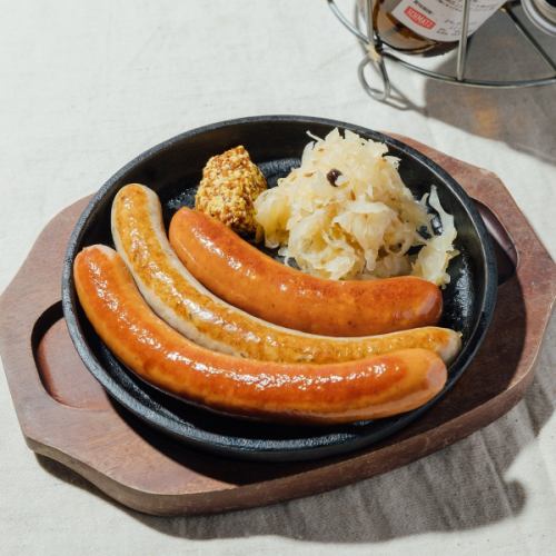 Juicy [special German sausages] served on a hot iron plate go perfectly with beer!