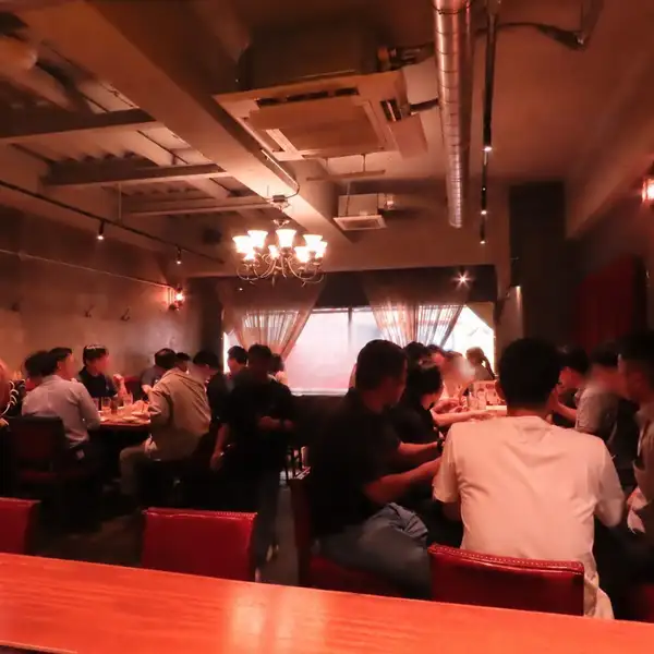 20~30名様の宴会にぴったりな、落ち着いた雰囲気のメインフロア。赤いソファと温かな照明に包まれた空間で、気の合う仲間とゆったりお食事をお楽しみいただけます。会社の忘年会や歓送迎会、同窓会など、少し特別な集まりにもおすすめ。お席のご相談もお気軽にどうぞ。