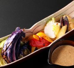 Warm seasonal vegetable salad with homemade garlic sesame dressing