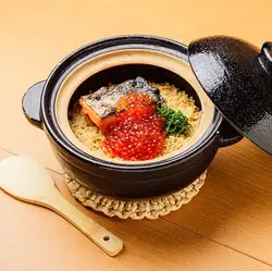 Silver salmon and salmon roe rice cooked in an earthenware pot