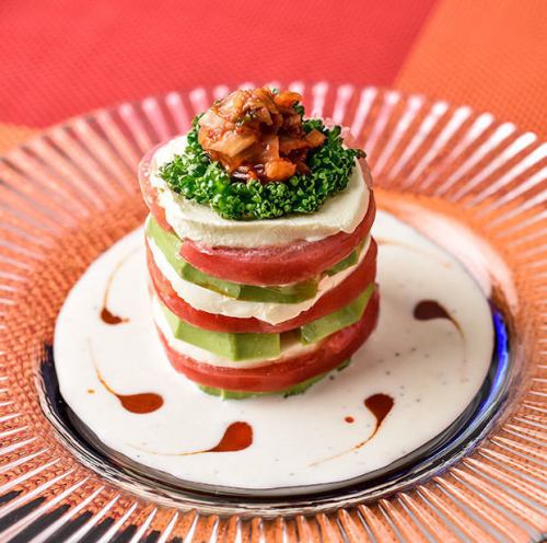 Millefeuille salad with avocado and cream cheese / Caesar salad with colorful tomatoes