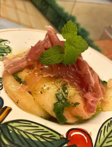 Cold pasta [Capellini] with peach, prosciutto, and a cold sauce made with what is considered the world's best Cambotto black pepper.