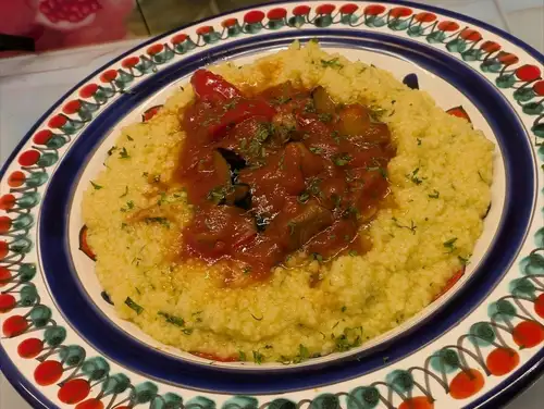 [Saffron-flavored couscous] Sicilian-style lamb stew with bell peppers, eggplant, and zucchini in a spicy tomato sauce.