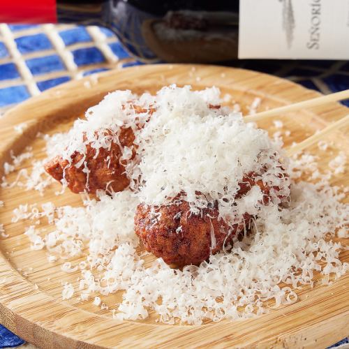 Pincho Morno Meatball Skewers Topped with Parmesan Cheese