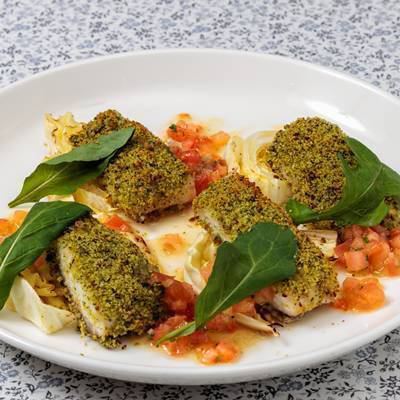 Herb-crusted sea bream baked with fresh tomato sauce