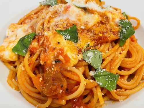 Spaghetti with tomato sauce and mozzarella and basil