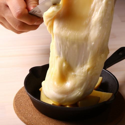 Raclette cheese served piping hot at your seat