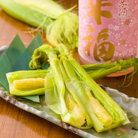 2 steamed young corn with husk