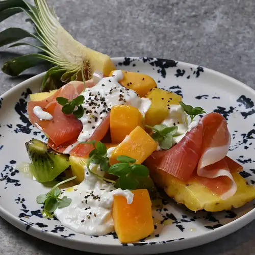 Tropical fruits and prosciutto in a stracciatella