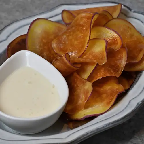 Freshly fried Naruto sweet potato chips with cream cheese and honey dip.