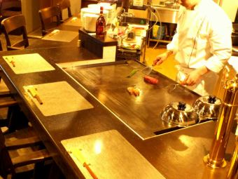 Counter seating where you can dine while watching the chefs baked on steel plates.