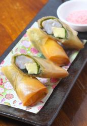 Crispy shrimp and cheese spring rolls with green shiso leaves