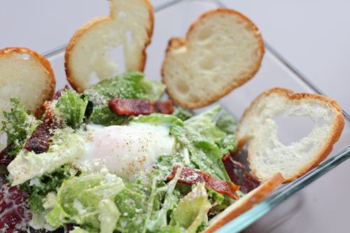 Caesar salad with raw ham and hot balls