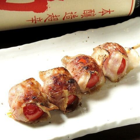 Pork skewers wrapped around tomatoes (one skewer)