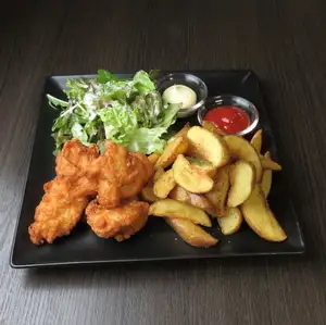 A platter of french fries and fried chicken.