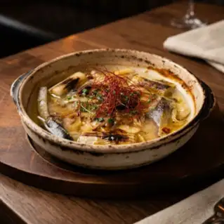 Piping hot! Ajillo with fatty marinated mackerel, mushrooms, and burnt leeks.