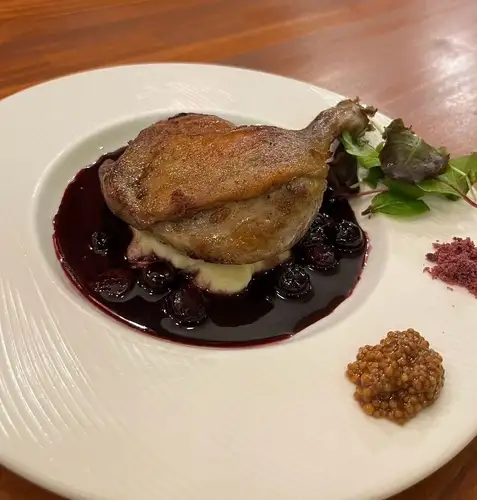 Duck leg confit with blueberry sauce