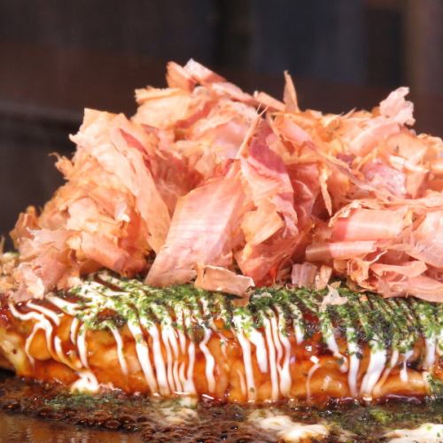 Superb okonomiyaki on a hot iron plate ...