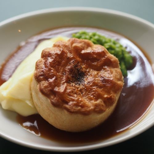 Pie and mash with gravy and green pea puree