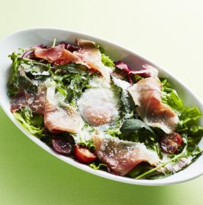 Caesar salad with raw ham and soft-boiled egg