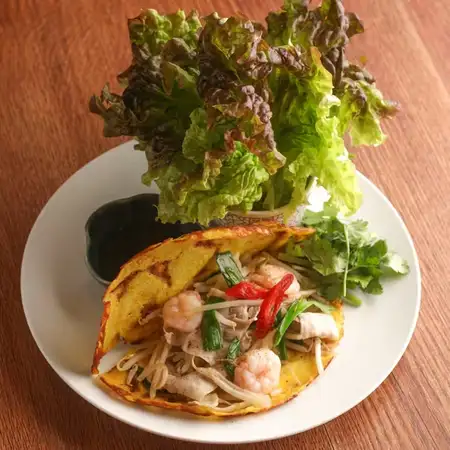 Banh Xeo with seafood and aromatic vegetables