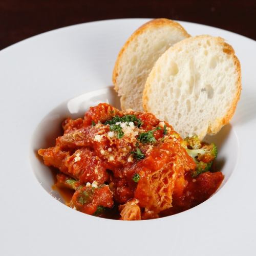 Beef tripe stewed in tomato sauce with baguette