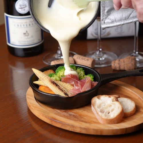 Raclette with 3 kinds of grilled vegetables and prosciutto served with baguette