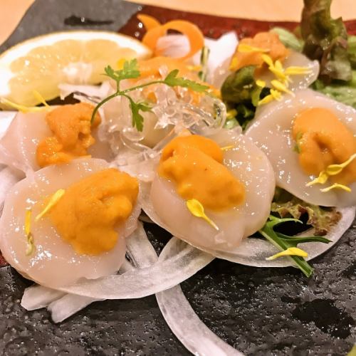 Scallops topped with sea urchin