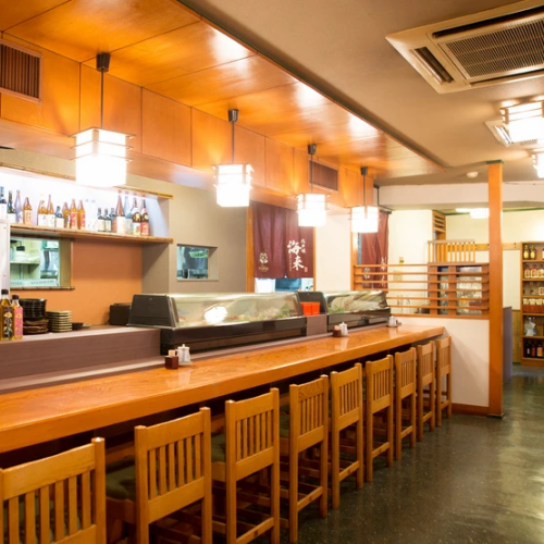 Wooden counter seats where you can enjoy conversation with the chef