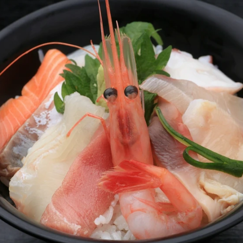 Bowl of rice topped with sashimi