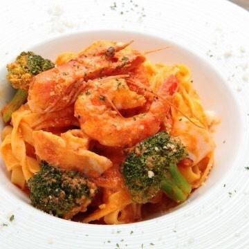 Tomato cream pasta with seafood and seasonal vegetables