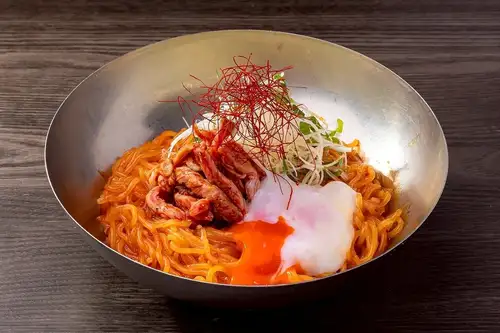 Spicy and flavorful bibim cold noodles with a seared yukhoe-style sauce