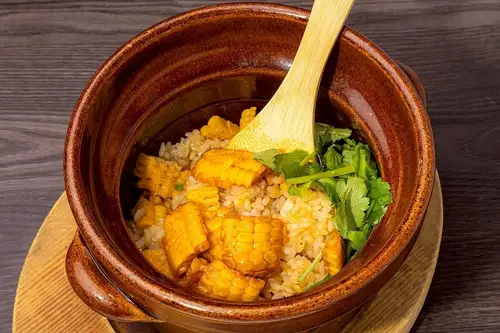 Corn and beef tongue rice cooked in an earthenware pot