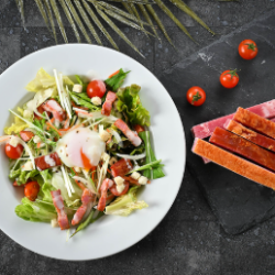 Caesar salad with soft-boiled egg and bacon