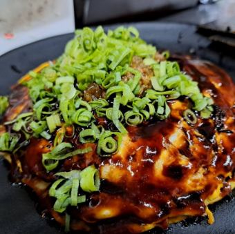 Modern grilled beef tendon covered in green onions