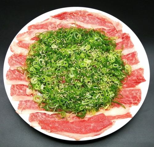 Thinly sliced kalbi covered in green onions