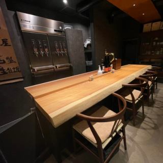 The seat in front of the bar counter.You can also see the drinks being made right in front of you.