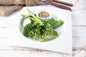 Homemade bagna cauda with green vegetables