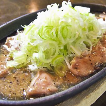 Grilled green onion salt tongue on an iron plate